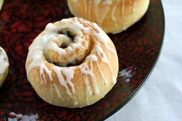 Rum Glazed Mincemeat Cinnamon Buns in red plate