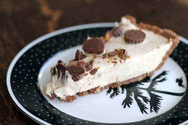 Slice of Peanut Butter Cup Pie with caramel drizzled over the top in a black and white vintage plate