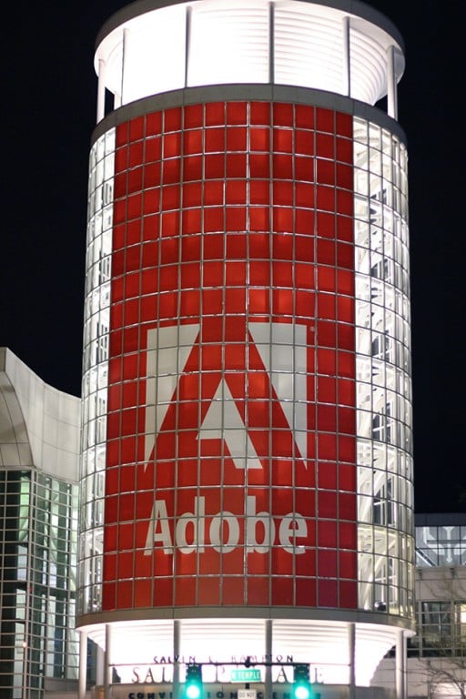 lighted building with adobe logo