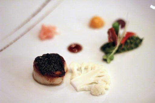 white plate with digby scallop and cauliflower