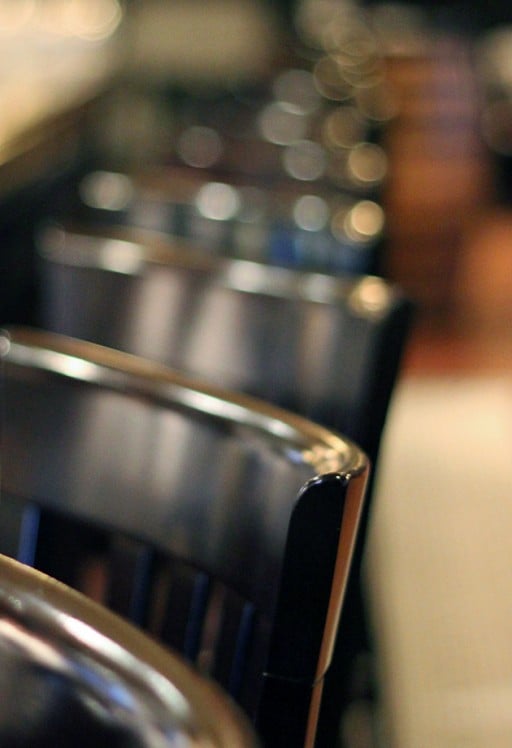 close up shot of the black chairs inside the bar