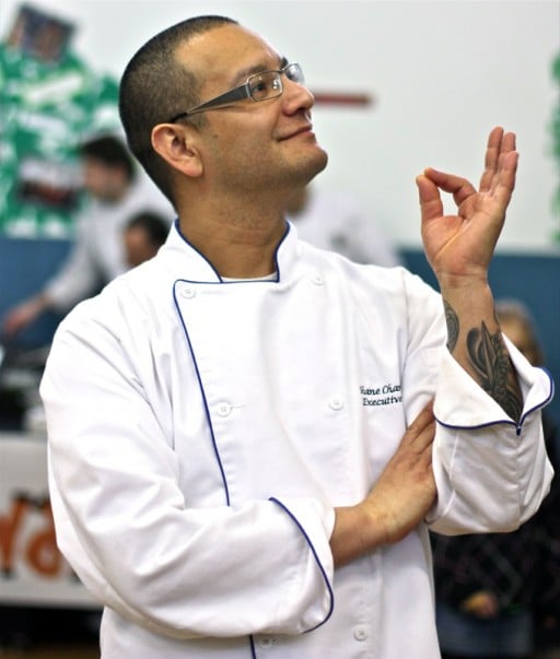 male chef in white uniform with one hand in OK gesture