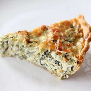 A Slice of Artichoke & Spinach Pie in white Background