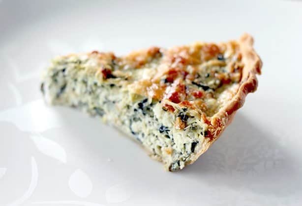 A Slice of Artichoke & Spinach Pie in with golden brown crust