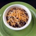 Crock Pot Black Bean Soup in a small white bowl on a green big plate