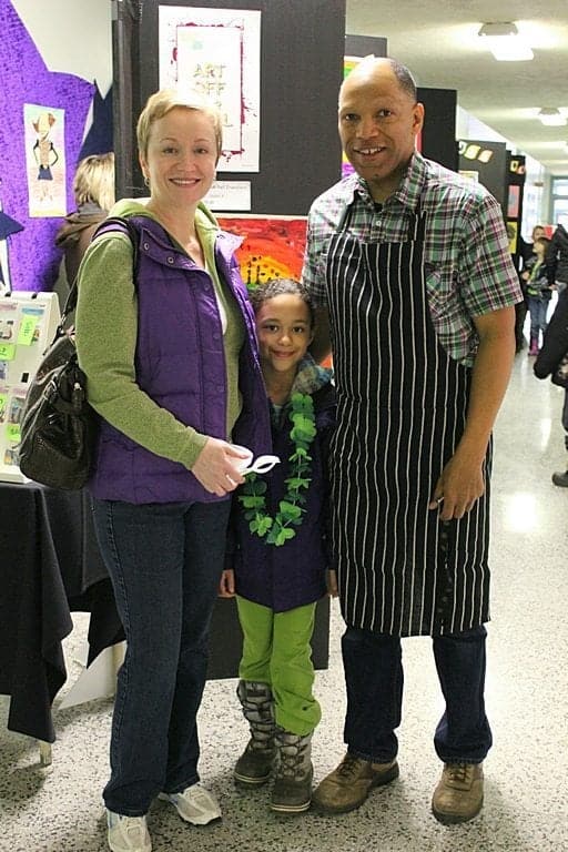 family picture of Mom, kid and Dad during the cook off event