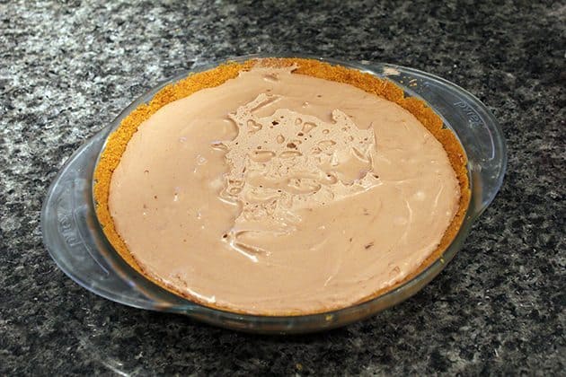 Mousse Pie with whipping cream on top in a Pyrex pie pan