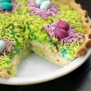 close up of Colorful coconut Custard Easter Pie in a white pie pan