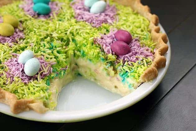 Colorful coconut Custard Easter Pie in a white pie pan