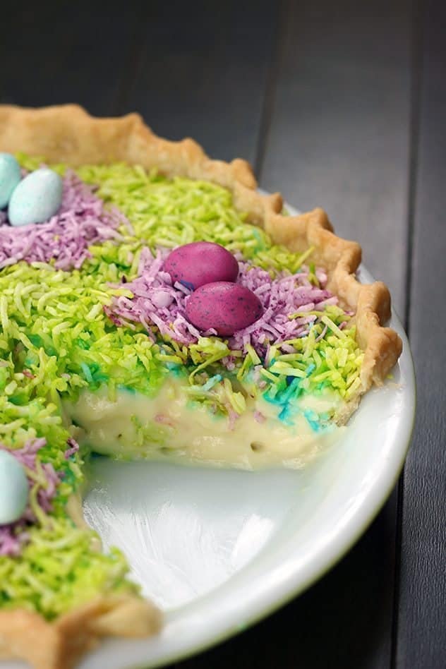 close up of Colorful coconut Custard Easter Pie in a white pie pan