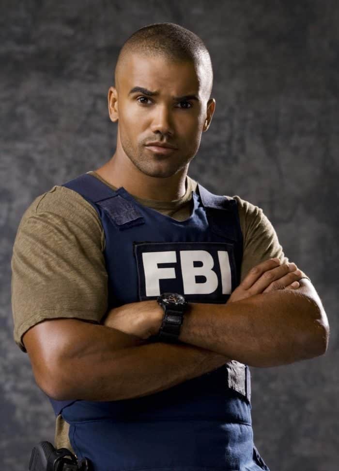 a man in brown shirt wearing an FBI vest