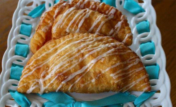 2 pieces of Apricot & Marmalade Fried Pies with Powdered sugar glaze on top