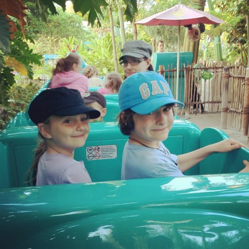 girl and boy siblings enjoying the ride in Disneyland