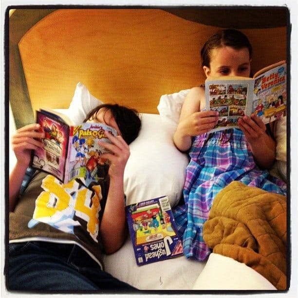 two kids reading comics during bedtimes