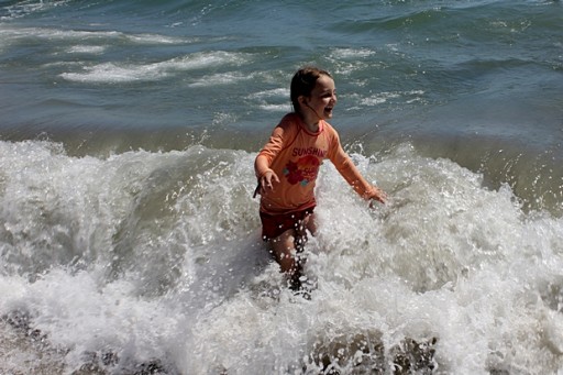 young girl in the sea water enjoying the waves