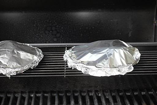 pie plate with the chicken breast sealed with tin foil