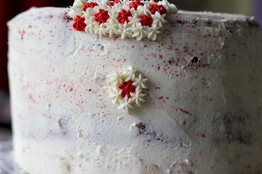 creating the 1st layer of star icing with white and red color on the cake