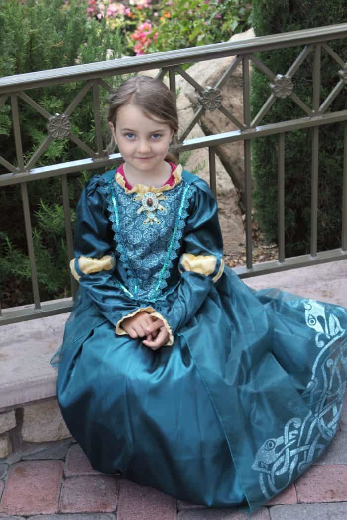 young girl wearing the dress of Disney Princess Merida