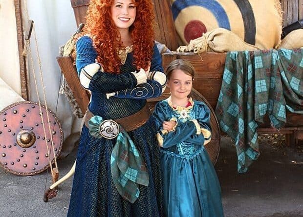young girl wearing princess Merida dress and the Disneyland character princess Merida