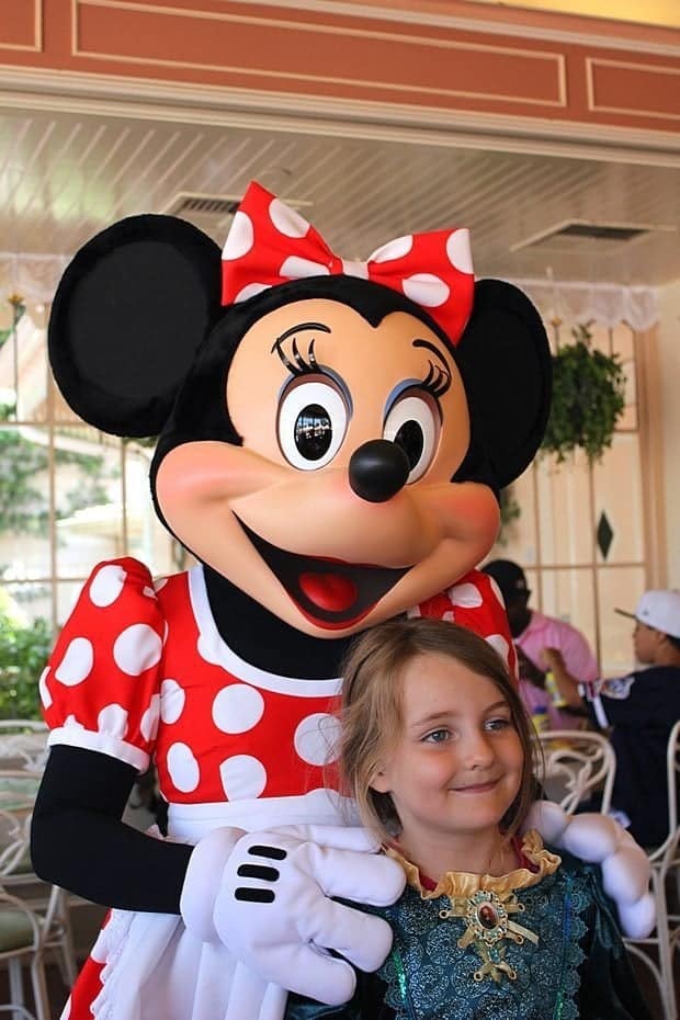 Minnie Mouse and little girl in green dress