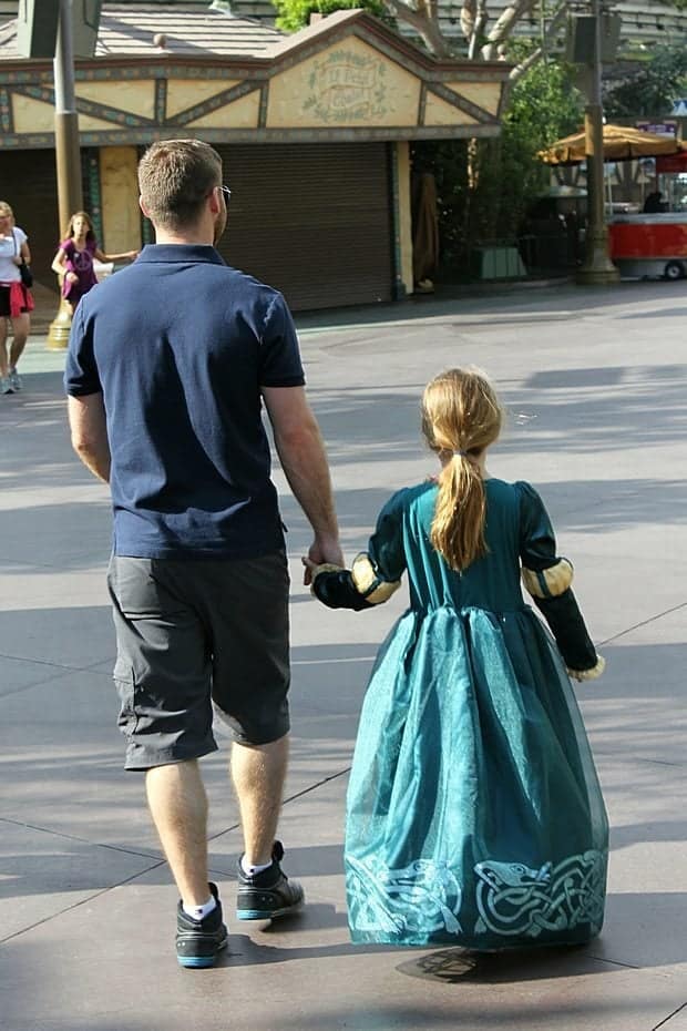 Dad holding the hand of his daughter while walking