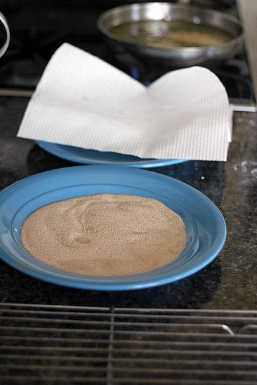 brown sugar in a blue plate for coating both sides and paper towel to remove oil