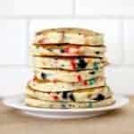 stack of bright and colorful Funfetti Pancakes in a white plate