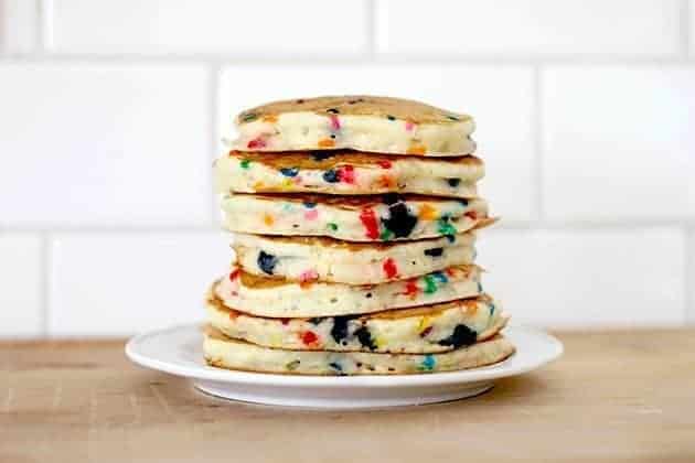 stack of bright and colorful Funfetti Pancakes in a white plate