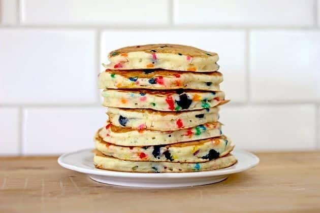 stack of bright and colorful Funfetti Pancakes in a white plate