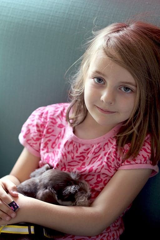 little girl with her cute little dog on lap