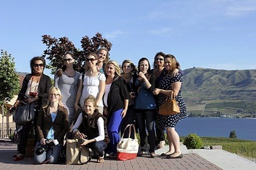 group picture of ladies taken at the winery with the background of mountains