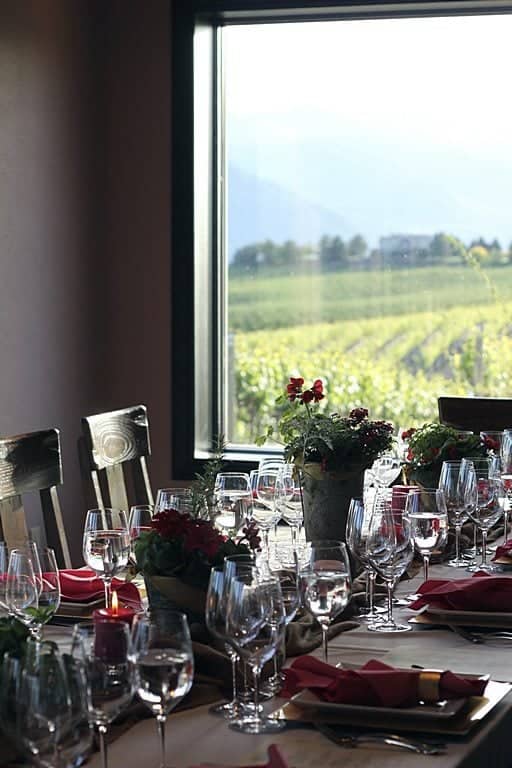 table set up in the winery for dinner near the window