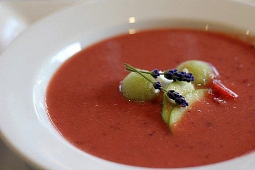 strawberry apple cold soup in a white bowl plate