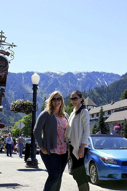 two ladies at the town of Leavenworth with the view of mountains on their background