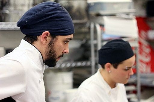 close up of chef with beard, wearing black head cap