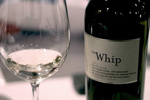 close up of a glass and a bottle of whip wine