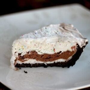 A slice of Easy Ice Cream Pie in a white plate