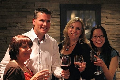 Edmonton oiler with three ladies holding glasses of wine