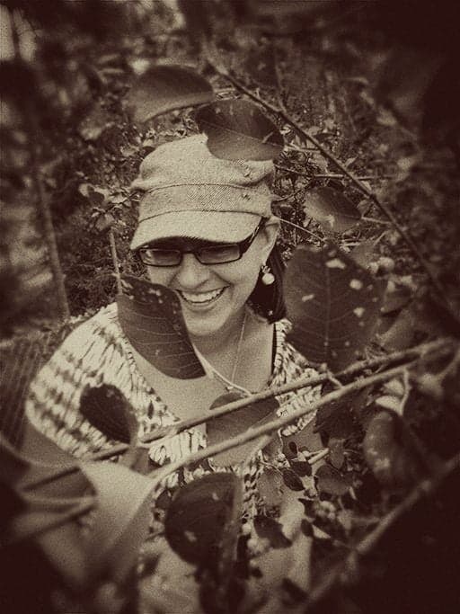 vintage photo of a girl picking Saskatoon berries