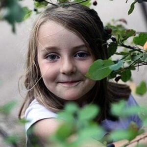 close up of little girl in Saskatoons tree