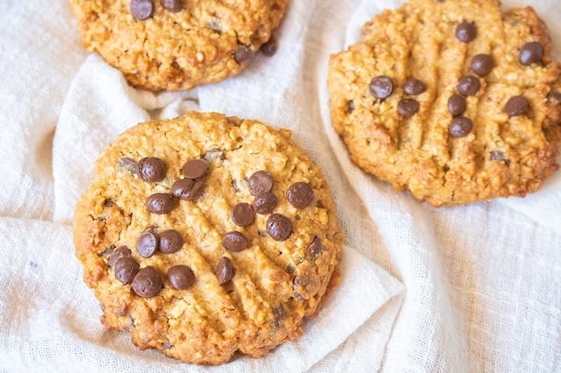 3 pieces Whole Wheat Oatmeal Chocolate Chip Cookies on a white cloth background