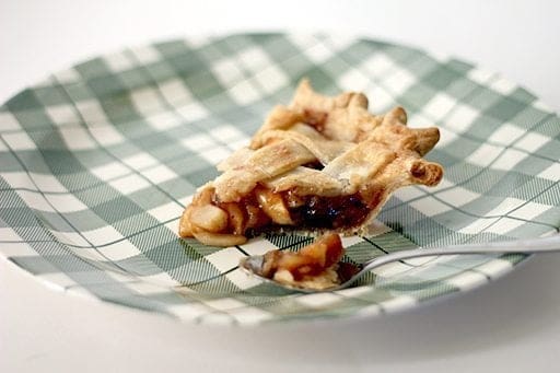 slice of amaretto raisin and crabapple pie in a checkered green plate