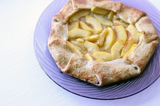close up Drunken Peach Galette in a glass plate on white background