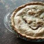 Apple Cream Pie in a Pyrex pie dish on wood background