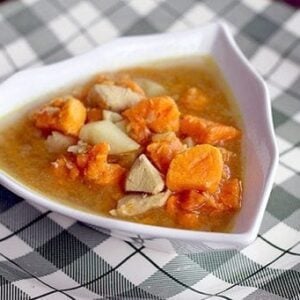 Potato Soup with Chicken and chunky sweet potatoes in triangular soup bowl on a checkered plate