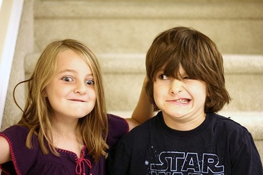 young girl and boy siblings in wacky faces for photo