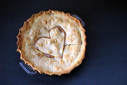 Peaches & Cream Pie in a pie dish with heart shape on top crust