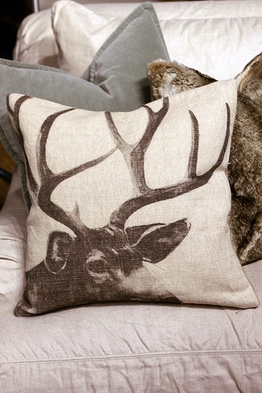 deer pillow mixed with a fur pillow behind it