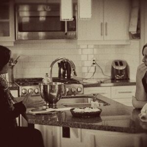 two women talking in the kitchen