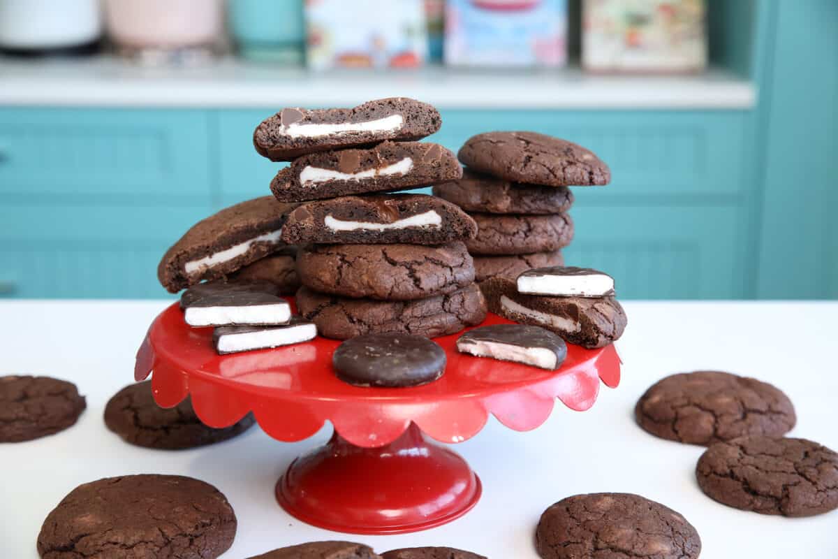 Double mint stuffed chocolate chip cookies stacked up on a red plate